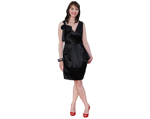 A Lifesize Cardboard Cutout of Kate Ford wearing a short black dress